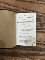 English New Testament title page showing publication details from 1918 by American Bible Society New York with torn lower corner and aged pages.