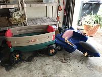 Side view of Little Tikes wagon with removable red sides and blue tri-mobile in garage setting