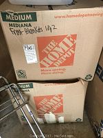 Two medium Home Depot cardboard boxes stacked, each labeled with handwritten 'Frost Blankets 10/2'.