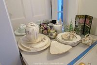 Full overview of the assortment including Aynsley floral dishes, porcelain figurines, Christmas plates and glass tree decorations
