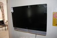 Front view of Vizio 32 inch flat screen TV mounted on wall.