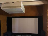 Vintage Zenith PRO851X projector mounted on ceiling aimed at the canvas projector screen framed in black
