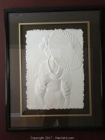Framed embossed paper art image of a Geisha holding a parasol, viewed from behind with textured white paper on white background, framed with dark matting and black frame.