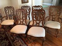All six carved wood dining chairs, four side chairs and two armchairs, upholstered seats