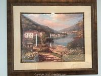 Large framed landscape painting showing lake, buildings, trees, flowers, and hills.