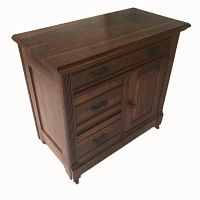 Front-left angled view of antique oak commode showing drawers on the left and cabinet door on the right, with brass hardware.