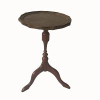 Front and side view of a small wooden side table with scalloped round top and tripod pedestal base.