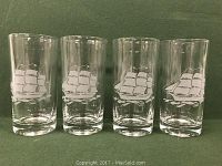 Set of four clear glass hi-ball glasses with sailing ship design etched in white on each.