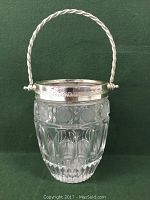 Clear image showing front view of crystal ice bucket with silver plated rim and twisted handle