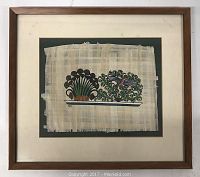 Framed artwork showing oil painting on papyrus sheet mounted on dark green mat board inside simple brown wooden frame.