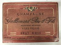 Photo of a vintage champagne label featuring Gallimard Père & Fils Brut Rosé from France with floral accent and product information.