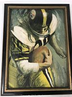Framed print on canvas showing a vintage Pittsburgh Steelers football player running with the ball, wearing a black helmet with the team logo and a yellow and black uniform.