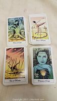 Top faces of tarot cards including Three of Cups, Four of Wands, Ten of Wands, and Princess of Cups.
