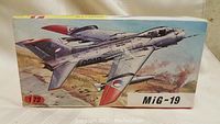 Front box artwork of the MiG-19 fighter jet model kit showing the aircraft in flight with detailed paint scheme.