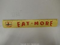 Yellow metal ruler with red Eat More text and Leapers logo, 12 inch measuring scale.