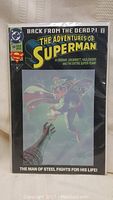 Front view of comic book with hologram cover, showing Superman flying and dramatic text of the issue. Comic is sealed in plastic protective sleeve.