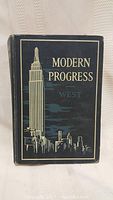 Front cover of the hardcover book titled 'Modern Progress West' with cityscape illustration.