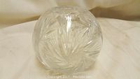 Side view of the vintage cut crystal ball vase showing intricate cut patterns on the spherical shape with small top opening.