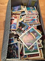 Image of a box filled with loose baseball cards primarily from the 1980s showing players like Dwayne Murphy and others.