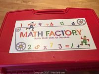 Closed red plastic case labeled 'Math Factory' with colorful numbers and robot images on the lid.