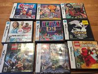 Photo showing 9 Nintendo DS game cases including Backyard Hockey, Phineas and Ferb Ride Again, Pokemon Platinum, FIFA Soccer 09, Tetris DS, Pokemon Black, Lego Star Wars: The Complete Saga, Lego Star Wars III, Lego Battles Ninjago, arranged on floor.