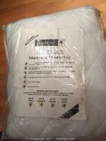 Packaged white quilted Sleep Factory Regular mattress protector labeled as double size, sealed in plastic