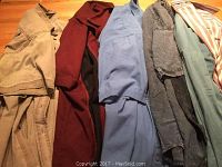 Photo showing six men's button-up shirts in various colors including beige, burgundy, light blue, denim, and a striped blue shirt.