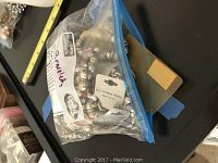 Zip-lock bag containing multiple bracelets with brand tags visible including Golden Stella.