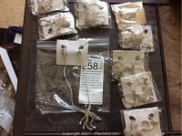 Lot of new necklaces and earrings with clear stones in silver-tone metal, all individually packaged