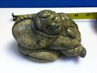 Side profile of the carving with measuring tape showing approx. 4" length