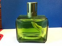 Green square glass Lampe Berger with metal ventilation cap and ceramic wick inside.