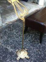 Brass-look adjustable music stand with ornate base