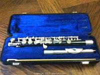 Blue interior case with older Artley piccolo showing some corrosion on keys and mouthpiece, arranged with headjoint and body in case
