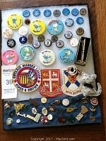 Large assortment of pins and patches arranged on display board, showing full lot variety.