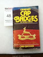 Photo of the book titled 'Canadian Cap Badges of World War II' by Chris Brooker, showing front cover with visible wear.