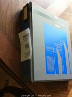 Closed binder containing the hockey cards with a label '65' on its spine.