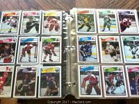 Two open binder pages showing multiple 1988-1989 OPC hockey cards in protective plastic sleeves with various NHL players.