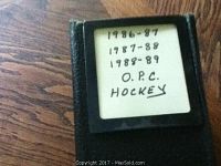 Black binder cover with handwritten label listing 1986-87, 1987-88, 1988-89 OPC Hockey