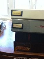 Edge labels of binders stacked showing handwritten or typed identifiers for 1989, 1990, and 1991 Don Russ and Topps binders