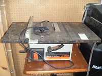 Full side view of Black & Decker 8 inch table saw showing table surface, cord, and wooden base.