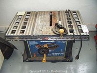 Front view of the Mastercraft 10 inch bench saw showing the table surface, fence, blade slot, adjustment knob, and power cord.