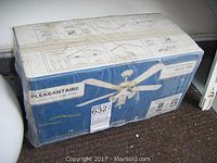 Photo of sealed box for Pleasantaire Mystic WB ceiling fan, showing brand and model name with partial product image.