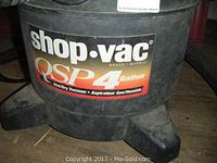 Close-up of the Shop Vac QSP 4 Gallon label showing brand and model details.