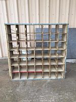 Front-facing view of the metal sorter showing grid of 49 compartments, light blue frame and off-white dividers
