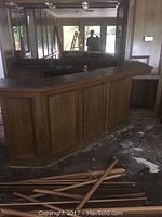 Front angled view of entire bar in situ with debris on floor