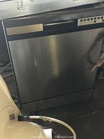 Full exterior view of stainless steel dishwasher with hoses