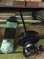 Photo of reclaimed black Casablanca ceiling fan with extended drop rod and blades visible, showing condition and style.