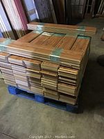 Stack of engineered oak planks strapped to pallet