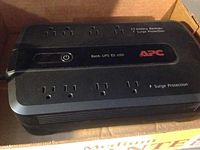 APC Back-UPS ES 650 battery backup and surge protector with multiple outlets.