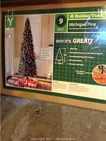 Photo of the boxed 9 foot pre-lit Michigan Pine artificial Christmas tree showing product info and features